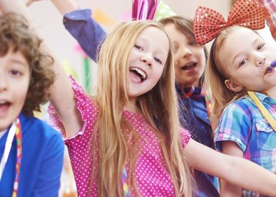 Smiling kids at colorful birthday party