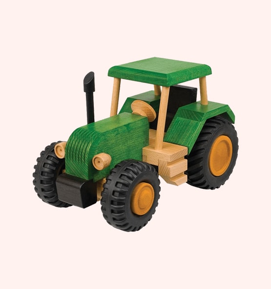 Green wooden toy tractor with black tires