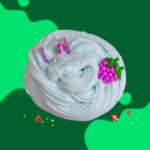 A swirl of light blue slime with small colorful charms on a green background.