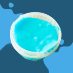 A round container filled with bright blue liquid on a blue surface.