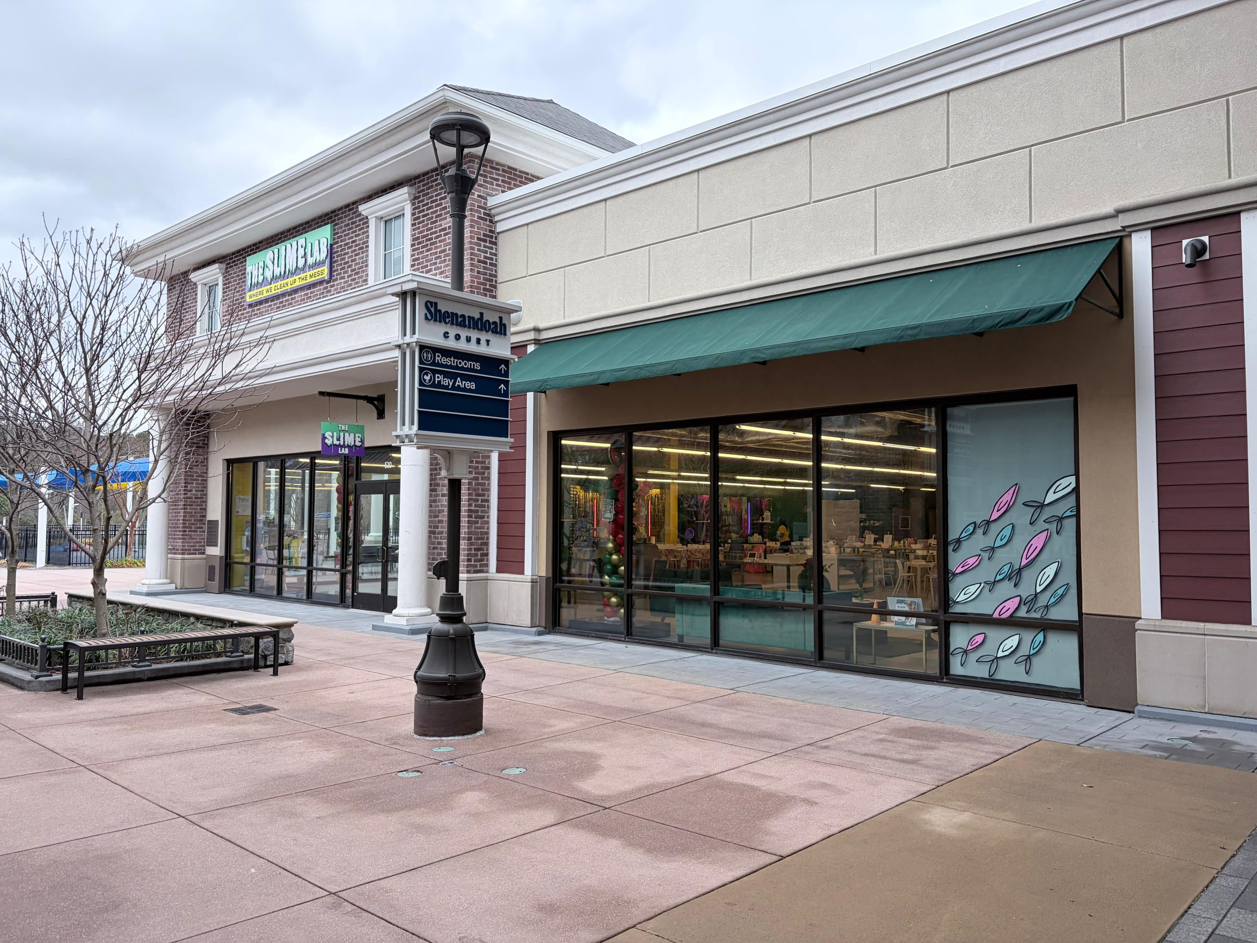 Empty outdoor shopping center storefronts with awning